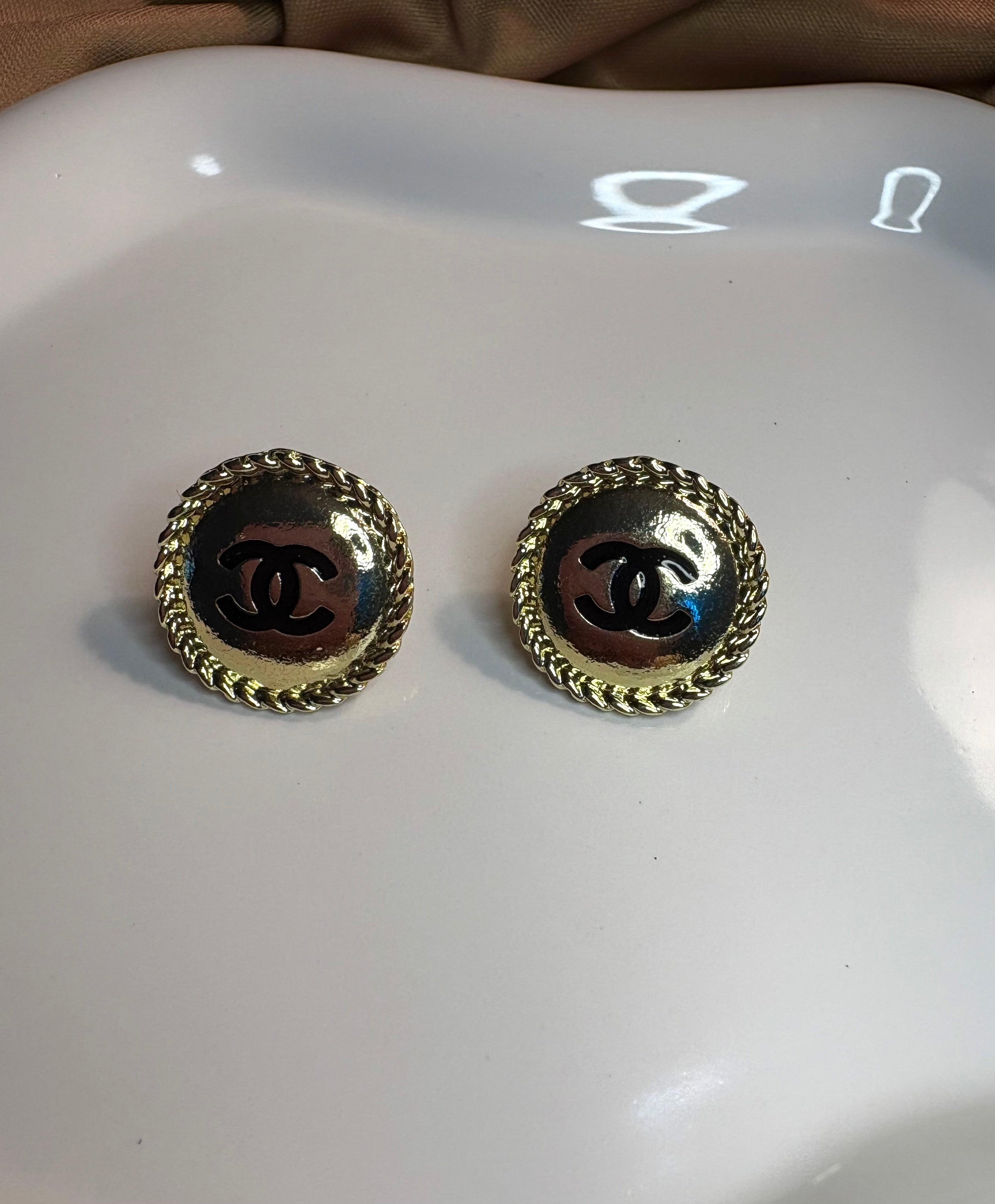 Button stud earrings.